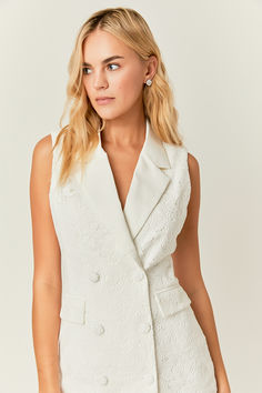 This classic blazer mini dress offers a timeless look. Featuring a slim fit with a mini length this dress is perfect for the office or a night out. Make a statement with the sleek sleeveless design. Elegant Semi-formal Spring Vest, Elegant Sleeveless Blazer For Office, Elegant Sleeveless Office Blazer, Semi-formal Sleeveless Vest For Spring, Chic Formal Sleeveless Vest, Elegant Sleeveless Blazer Dress For Formal Occasions, Formal Fitted Summer Vest, Elegant Spring Blazer For Date Night, Elegant Blazer For Date Night In Spring