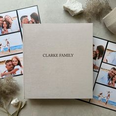 a family album with photos and flowers on the table next to it that says, clarke family