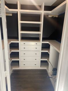 an empty walk in closet with shelves and drawers