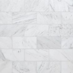 a white marble tile wall that looks like it has been made out of different types of tiles