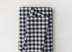 a black and white checkered towel hanging on a wall