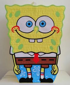 a spongebob cut out sitting on top of a white table next to a wall