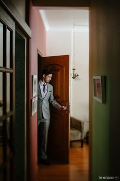 a man in a suit is standing at the door