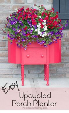 an upcycled porch planter with flowers in it