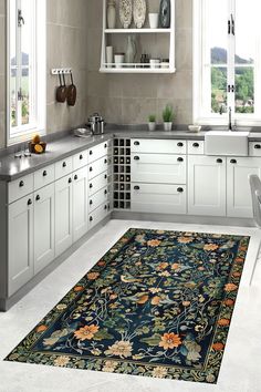 a kitchen with white cabinets and an area rug