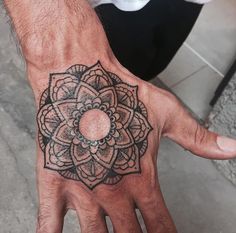 a man's hand with a tattoo on it