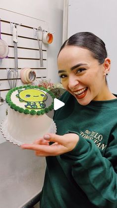 a woman holding a cake in front of her face