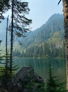 a lake surrounded by trees in the mountains