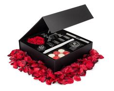 a black box with red flowers and candles