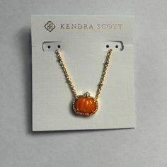 Metal - 14k Yellow Gold Over Brass Material - Orange Mother Of Pearl Closure - Lobster Clasp W/ Single Adjustable Slider Bead Size - 19" Chain, 0.6"L X 0.55"W Pendant Celebrate The Season In Style With The Pumpkin Gold Short Pendant Necklace In Orange Mother-Of-Pearl. A Charming Take On The Classic Pendant Style, You’ll Wear This Seasonal Necklace For Every Fall Festivity, From Pumpkin Carving To Trick-Or-Treating. Due To The One-Of-A-Kind Nature Of The Medium, Exact Colors And Patterns May Vary Kendra Scott Pumpkin Necklace, Kendra Scott Necklace October, Orange Round Pendant Necklace, Orange Gemstone Pendant Necklace, Unique Orange Pendant Necklace, Short Pendant Necklace, Gold Shorts, Kendra Scott Jewelry, Gold Orange