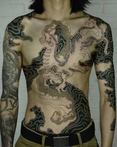 a man with tattoos on his body and chest