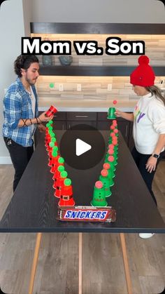 two people standing in front of a table with candy