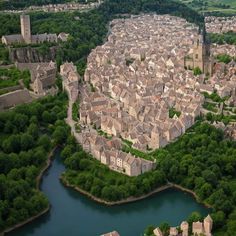 an aerial view of a city with lots of buildings and trees in the foreground