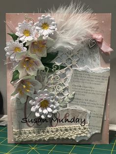 a close up of a greeting card with flowers and feathers on the front, along with words that read susan muddyy