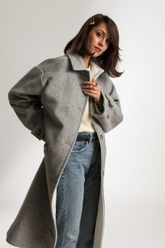 The Cathrine Wool Coat is a relaxed fit, single-breasted carcoat. This woolen, heavy weight style has a soft texture and finish with piping on the inside. It features welt pockets and visible stitching detailing, with button closure and cuff straps. This sustainable coat is tailor made and on demand. It takes us 10 hours to make this coat. PLEASE ALLOW 1-3 BUSINESS DAYS FOR PRODUCTION Classic Outerwear With Straight Hem For Winter, Fall Outerwear Single Breasted With Straight Hem, Fall Single Breasted Outerwear With Straight Hem, Single Breasted Outerwear With Straight Hem For Fall, Everyday Outerwear With Welt Pockets And Straight Hem, Everyday Outerwear With Straight Hem And Welt Pockets, Fall Outerwear With Concealed Placket And Straight Hem, Oversized Winter Outerwear With Welt Pockets, Fall Outerwear With Button Closure And Straight Hem