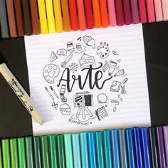 a notebook with the word art on it next to colored crayons and markers