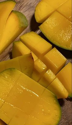 sliced up mangoes on a wooden cutting board