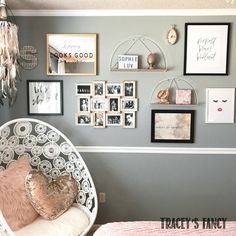 a bedroom with pictures on the wall and a hanging chair in front of it,