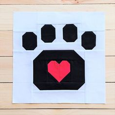 an animal's paw with a heart in the center on a piece of paper