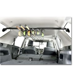 the inside of a van with several items hanging from it's roof rack and two rows of seats