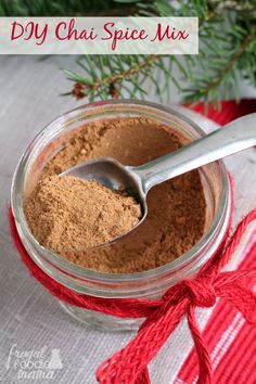 homemade diy chai spice mix in a glass jar with a spoon on top