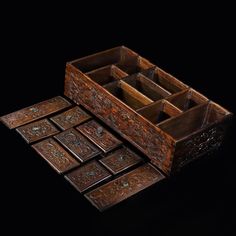 an assortment of wooden boxes on a black background