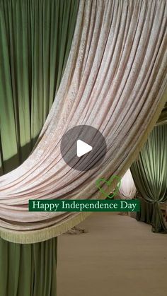 an open curtain with the words happy independence day written in green and white on it