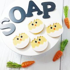 a white plate topped with cut out eggs and carrots next to the word soap