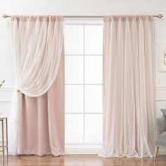 a living room with a couch and window covered in pink drapes on the windowsill