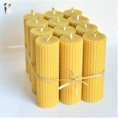 several beeswax candles wrapped in twine and tied with string on white background