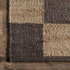 a brown and black checkered rug on top of a wooden floor