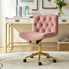 a pink office chair sitting on top of a white rug in front of a desk