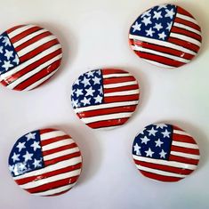 four american flag buttons sitting on top of each other