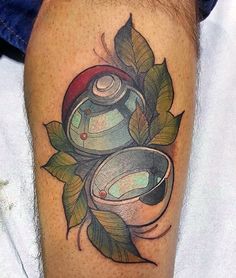 a tattoo on the leg of a man with an image of two jars and leaves