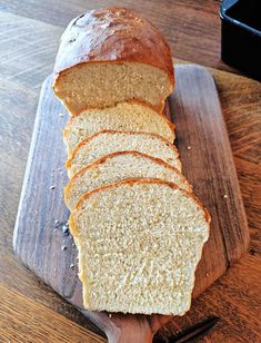 a loaf of bread sitting on top of a wooden cutting board