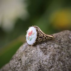 Victorian style German Tulip Cameo. Available on an antiqued brass or silver adjustable vintage style ring. Vintage Oval Flower Ring, Vintage Open Enamel Ring For Gift, Vintage Enamel Open Ring Gift, Vintage Adjustable Gold Flower Ring, Adjustable Vintage Gold Flower Ring, Vintage Collectible Flower Ring, Collectible Vintage Flower Ring, Adjustable Retro Ring, Retro Adjustable Ring