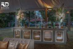 an outdoor bar is set up under a tent