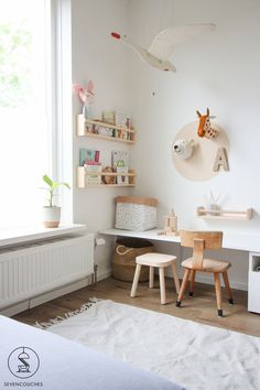 a child's room with white walls and wooden furniture