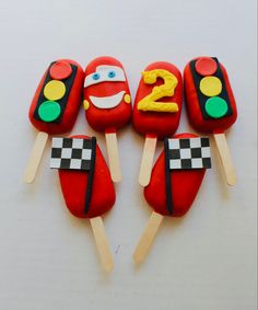 some kind of cake that looks like hotdogs on sticks with numbers 2 and 3