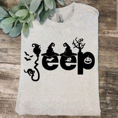 a t - shirt with the word eep on it next to a potted plant