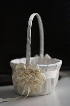 a white flower basket sitting on top of a table