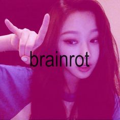 a girl with long black hair pointing at the word brainrot in front of her