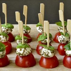 small appetizers with tomatoes and mozzarella sprinkles on wooden skewers