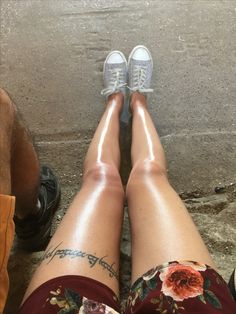 the legs and ankles of a woman with tattoos