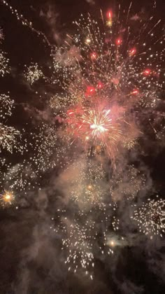 fireworks are lit up in the night sky