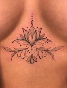 a woman's chest with a flower tattoo on it