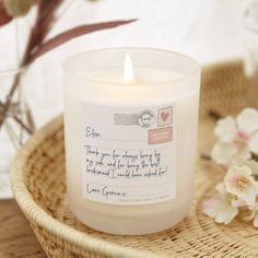 a candle sitting on top of a wicker basket