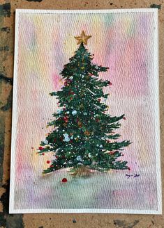 a painting of a christmas tree on a piece of paper