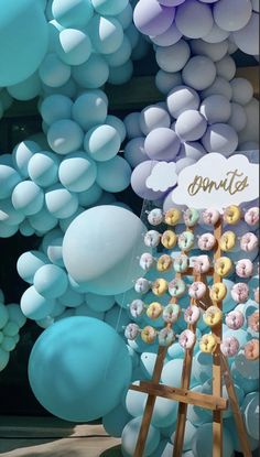 there is a display with balloons and donuts on it