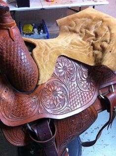 the saddle is made up of brown leather and has a tan suede on it